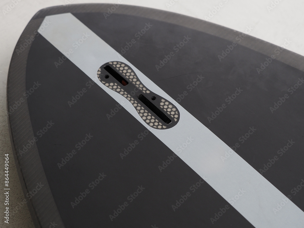 Close-up of an FCS surfboard fin box illustrating proper fin installation