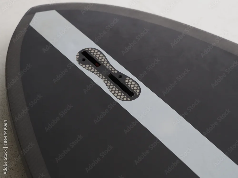 Close-up of an FCS surfboard fin box illustrating proper fin installation